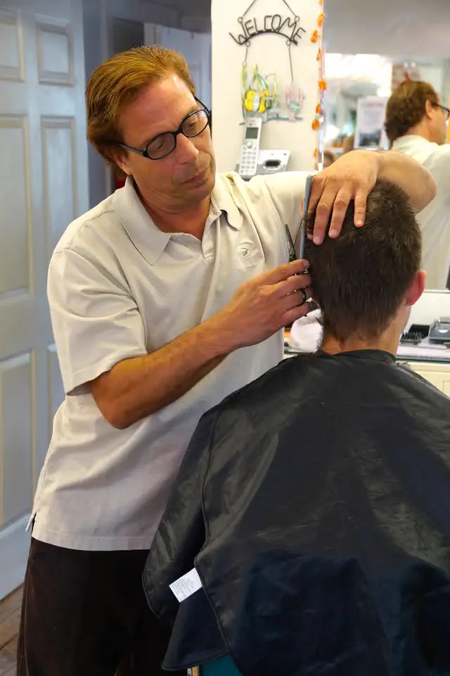 Greg cutting a client's hair at the shop